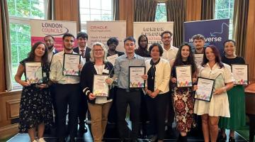 The winners of the London Borough Apprenticeship Awards on the stage at the event holding their certificates and trophies.